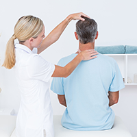 Chiropractor working on a neck to see where the posture issues are coming from